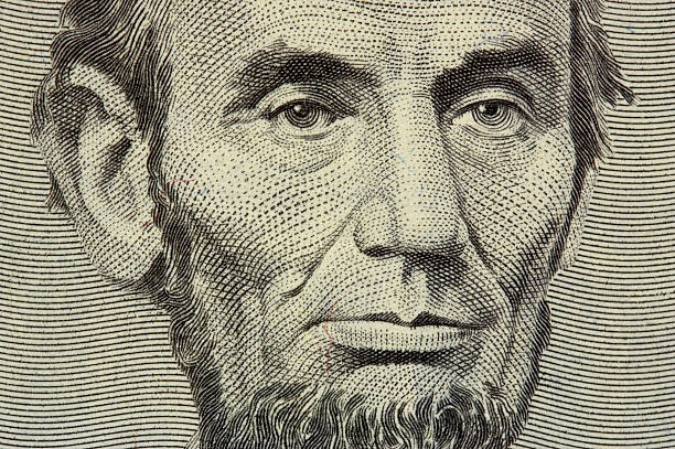 President Abraham Lincoln on the obverse of a five dollar bill for background.