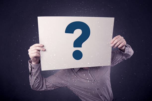 istock Businessman holding paper with question marks 922667818
