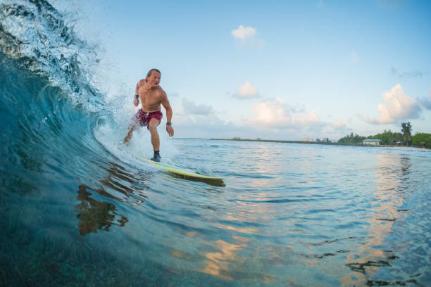 istock Young man surfer rides the ocean wave 922667964