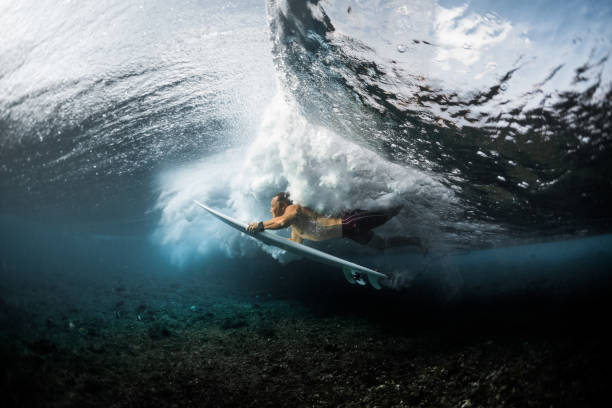 istock Young surfer dives under the ocean wave 922668108