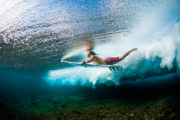 istock Young surfer dives under the ocean wave 922668154