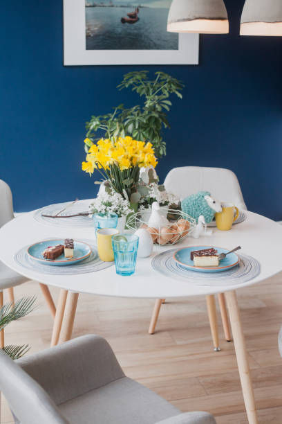 istock Beautiful spring table decoration with flowers and cake, vertical 922670278