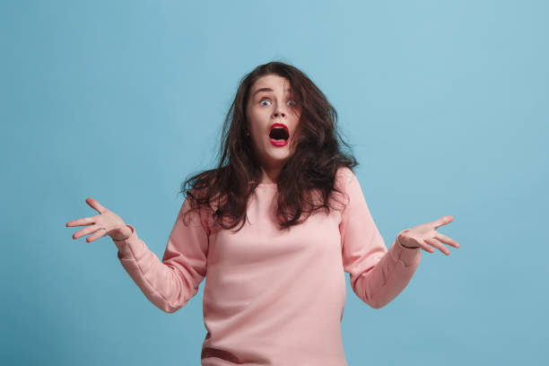istock The squint eyed woman with weird expression isolated on blue 922671876