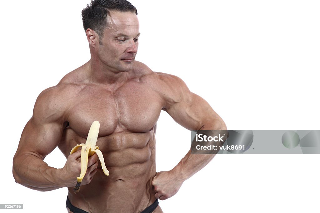 Bodybuilder mangiare banane - Foto stock royalty-free di A petto nudo