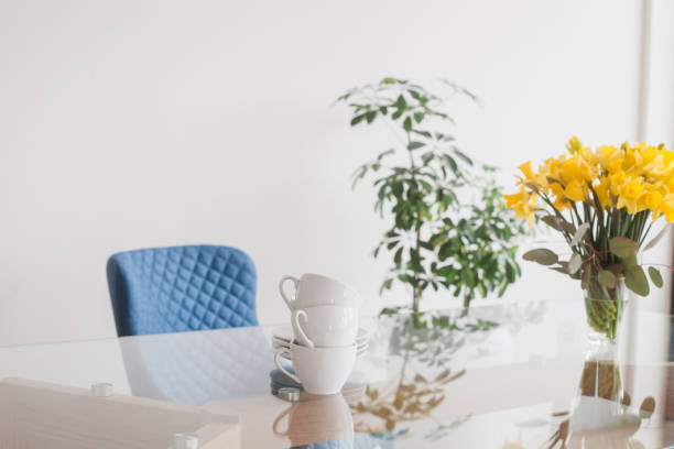 istock Glass table top with cups and spring bouquet with daffodils and eucalyptus 922672306