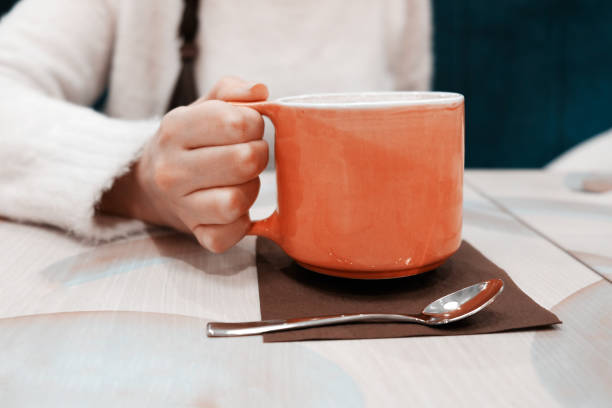 istock Girl holding a mug of coffee 922673752