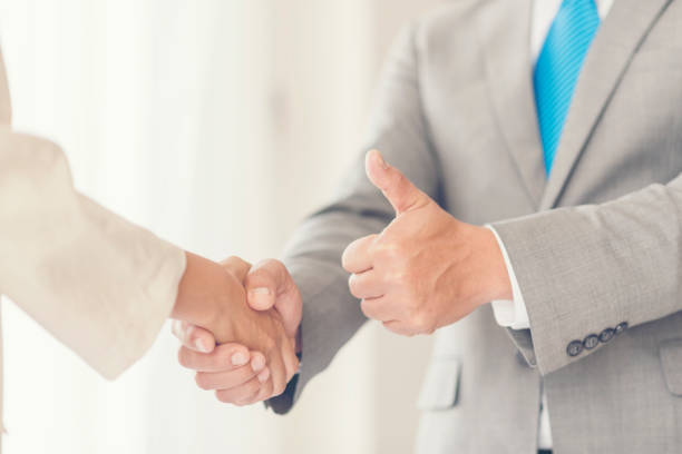 istock business people join hand while meeting in office 922674396