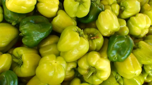 display of yellow chili pepper on a market