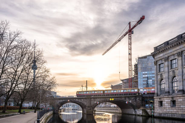 istock train passing bridge over Berliner river at sunrise 922675426