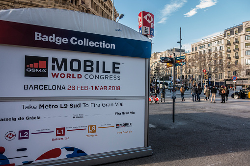 Barcelona, Spain. February 2018: Mobile world Congress or MWC 2018 Badge collection, located at the crossroads of Passeig de Gràcia and Gran Via de les Corts Catalanes.