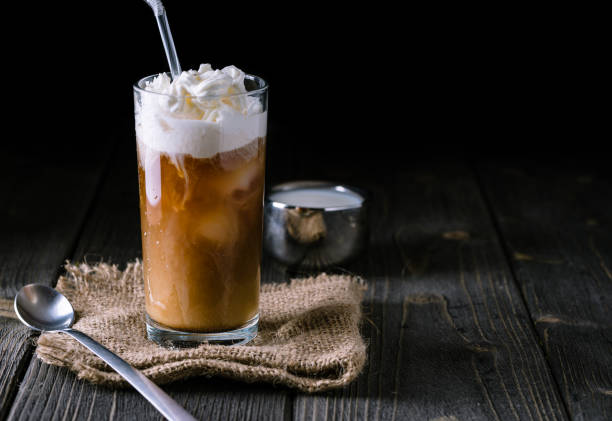 istock Iced coffee in a tall glass with cream poured over. 922676826