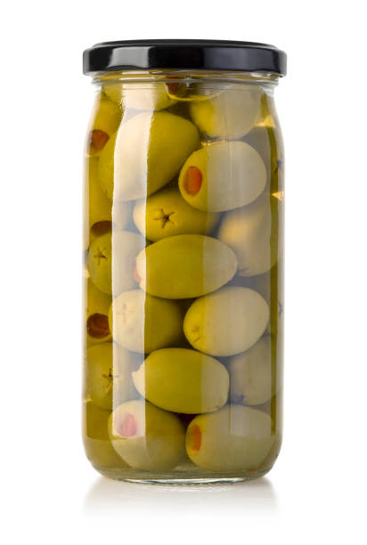 pickled green olives in jar on white background