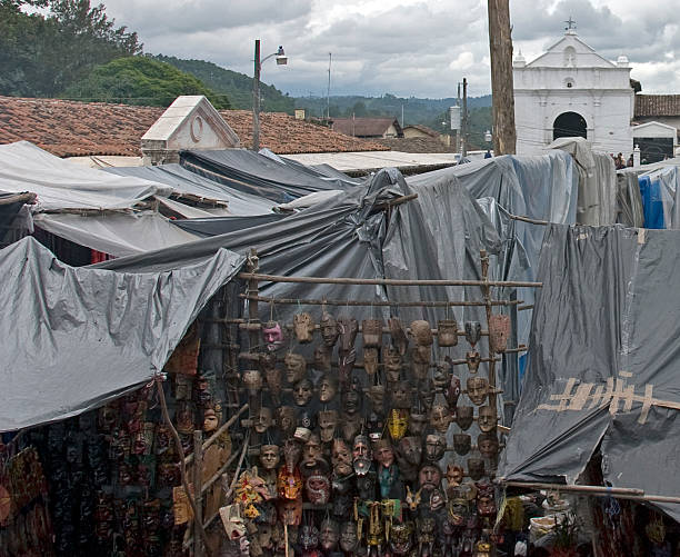 Masks, rooftops Church, Chicastango, Guatemala stock photo