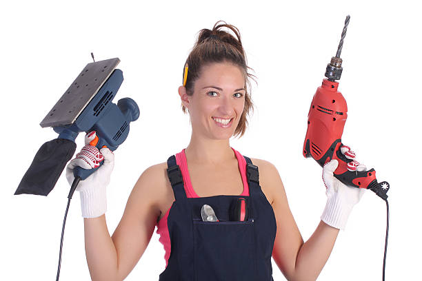 istock woman with auger and sander 92267836