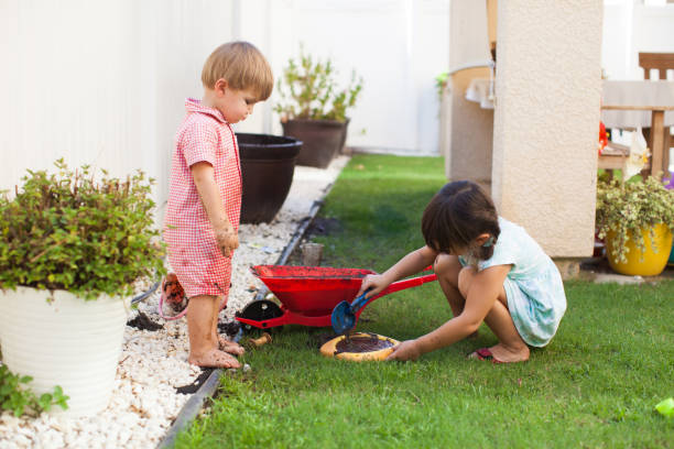 istock Toddler Kids Playing Outside With Mud in Summer 922680392