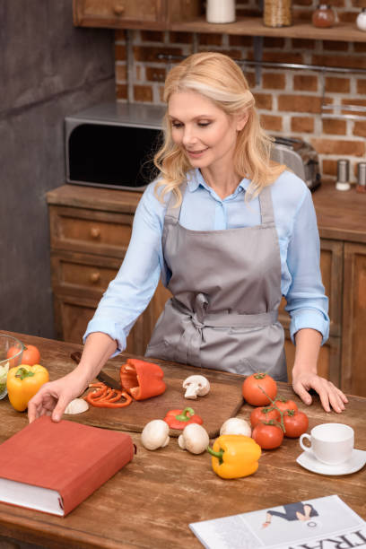 istock woman taking recipe book in kitchen 922680568