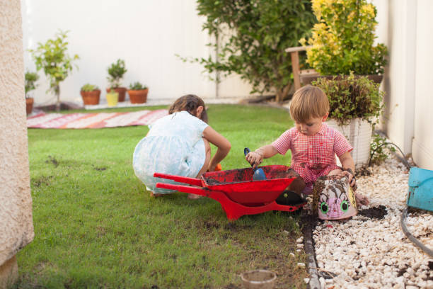 istock Toddler Kids Playing Outside With Mud in Summer 922680742