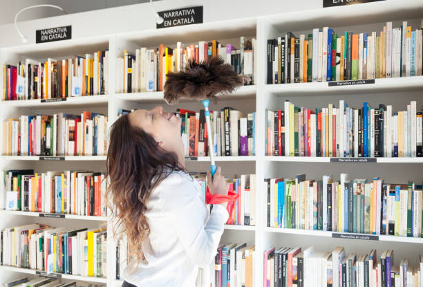istock Young owner with duster in her store 922680920