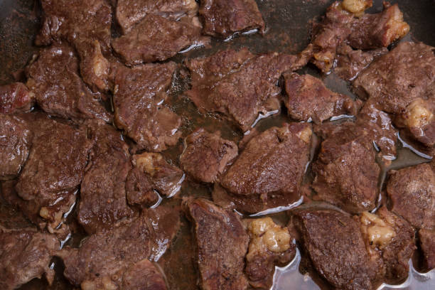 istock Meat beef fried pieces in the oven, close-up as background, texture 922682300