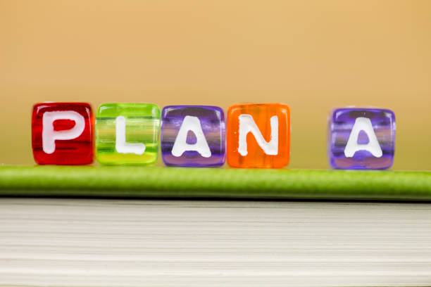 istock Business strategy and marketing concept, cube dices with word PLAN A on green book. 922683384