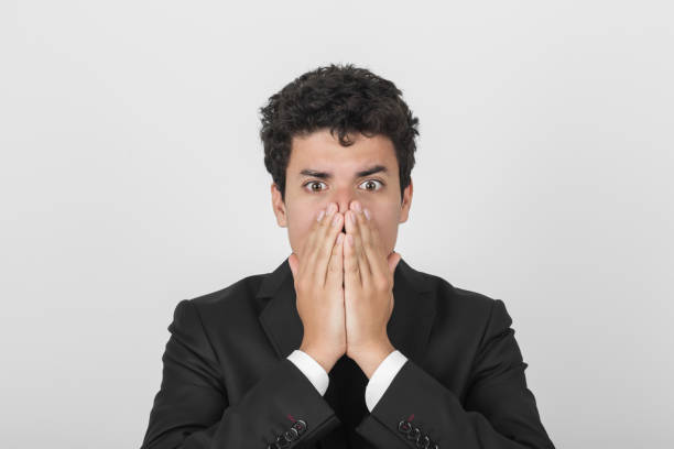 istock Young businessman hiding his mouth 922684046