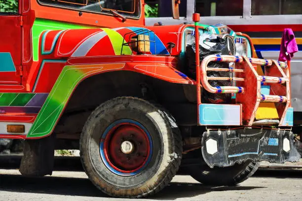 Filipino orange-red dyipni-jeepney car. Public transportation in Sagada town-originally made from US.military jeeps left over from WW.II locally altered-now from japanese surplus. Igorot-Philippines.