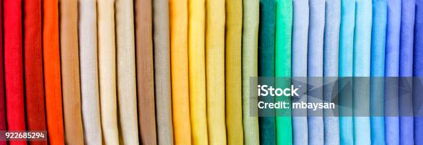 Rainbow Clothes Background Pile Of Bright Folded Clothes Stock Photo - Download Image Now