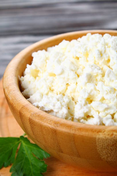 istock Home cottage cheese in a bowl on a wooden table. 922685990
