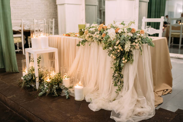 istock Wedding table decorated with candles, flowers and eucalyptus in an ancient building 922686302