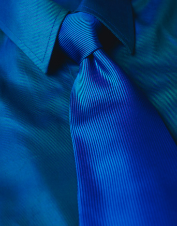 A mans blue shirt and tie photographed on 5x4 film stock.