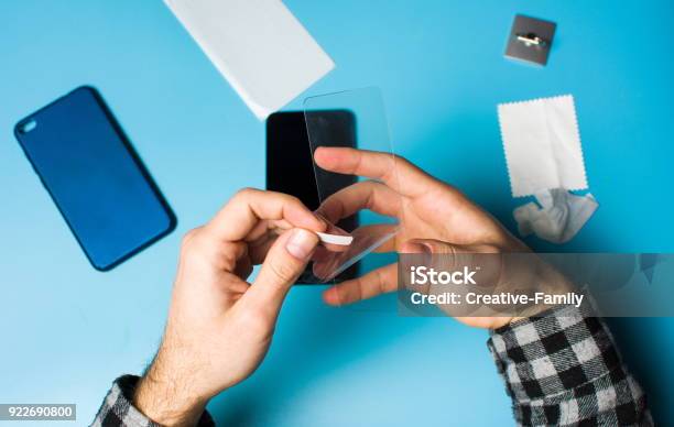 Man Applying Protective Tempered Glass To Phone Screen Stock Photo - Download Image Now