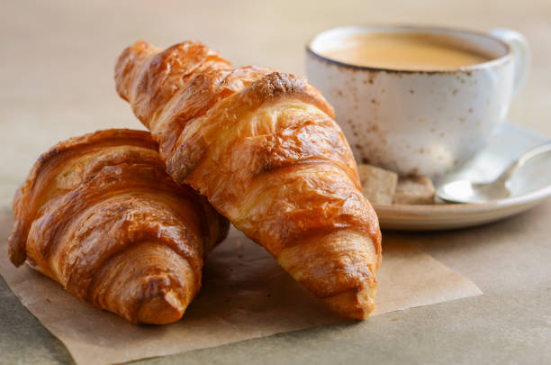 istock Cup of fresh coffee with croissant on concrete background. 922691148