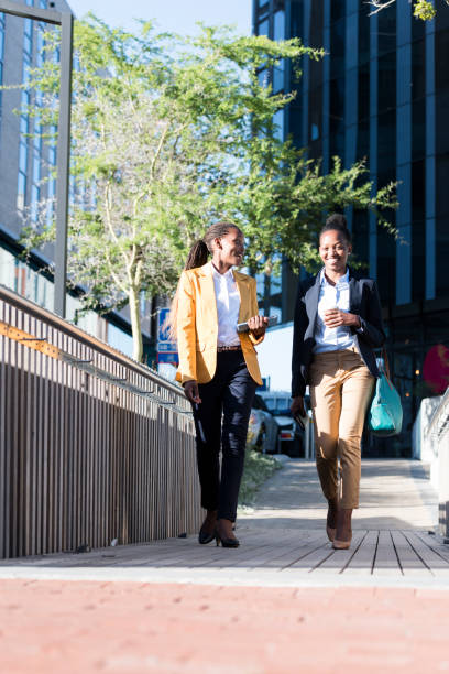 istock Business women walking with coffee and tablet computer 922692666