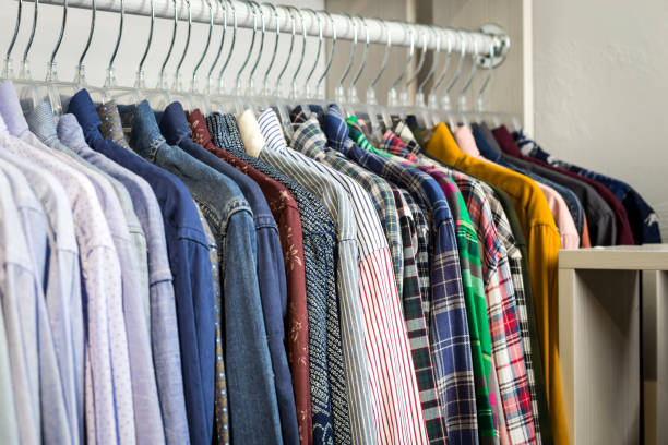 istock Clothes hang on a shelf in a store 922693748