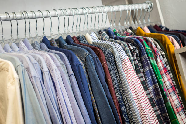 istock Clothes hang on a shelf in a store 922693942