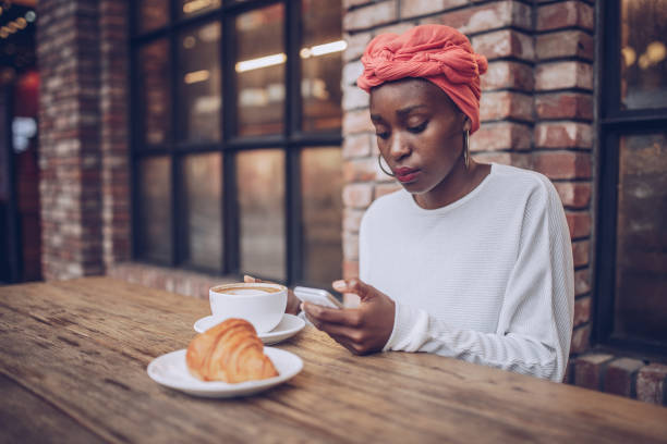 mujer desayunando en la cafetería - croissant telephone coffee shop on the phone fotografías e imágenes de stock