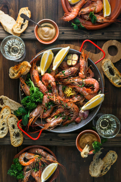 istock Huge prawns in a pan with bread, sauce and wine 922697416