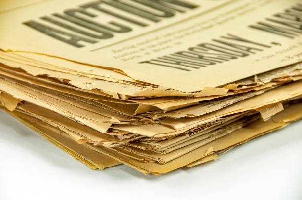 istock Stack of 100 year old yellowed newspapers 922698392