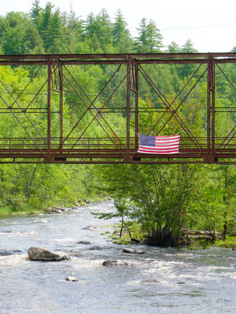 istock American Flag flies over an old train bridge. 922699314