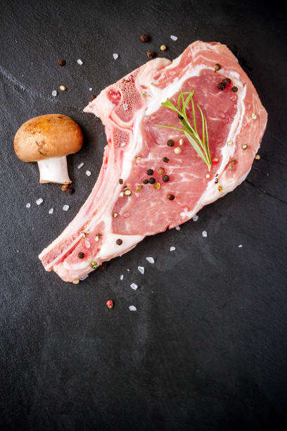 istock Raw veal cutlet at black slate plate 922700720