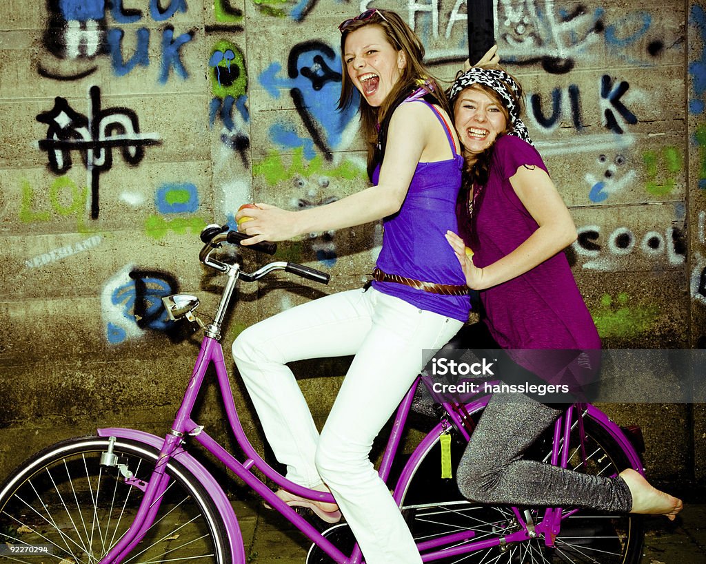 girls have fun on a bicycle  Adolescence Stock Photo