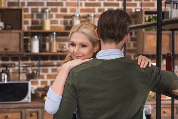 istock attractive wife hugging husband in kitchen 922704270