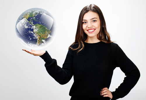 Young woman holding a world globe