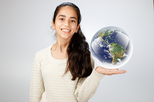 Young girl holding a world globe