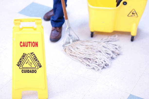 istock Unrecognizable man mopping floor in office building. 922706444