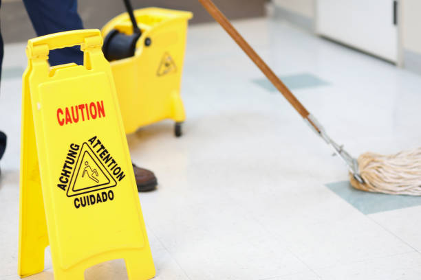 istock Unrecognizable man mopping floor in office building. 922706510