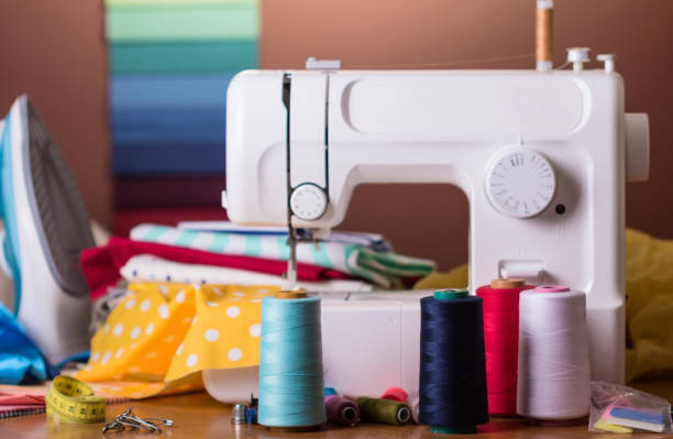 istock Modern sewing machine, spool with fiber, sewing accessories 922707206