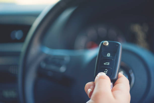 woman holding a car key. - car test drive car rental women imagens e fotografias de stock