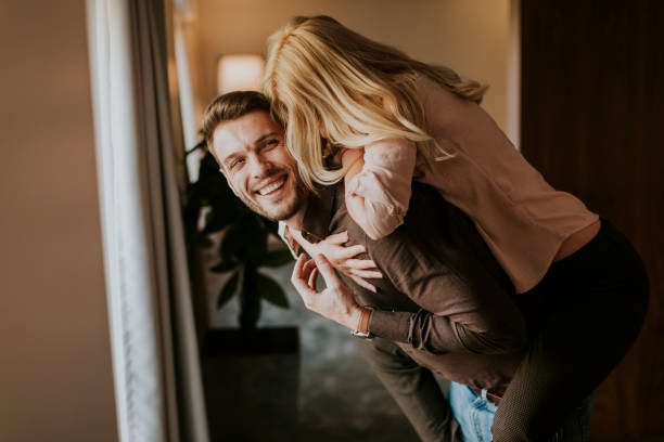istock Young man carrying young woman on his back 922708446