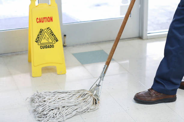 istock Unrecognizable man mopping floor in office building. 922709182